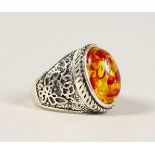 A SILVER AND AMBER RING.