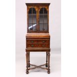 A GOOD, SMALL, VICTORIAN STYLE FIGURED WALNUT BOOKCASE ON STAND, with a pair of glazed doors above a