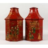 A PAIR OF TOLE WARE RED OCTAGONAL TINS, with Chinese designs. 15ins high.