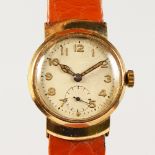 A MID-SIZE 9CT GOLD CASED WRISTWATCH, with subsidiary second dial at six o'clock, with brown leather