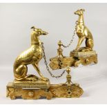 A GOOD PAIR OF 19TH CENTURY BRASS CHENETS, modelled as tethered greyhounds, seated on a cushion.