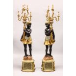 A LARGE PAIR OF BLACKAMOOR STANDING LIGHTS, a Blackamoor holding a double row of six lights. 6ft