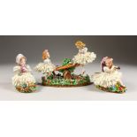 A SITZENDORF PORCELAIN GROUP, young girls on a seesaw; together with a pair of similar figures (3).