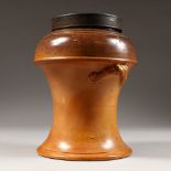 A SALT GLAZE TERRACOTTA TOBACCO JAR, with metal cover. 9ins high.