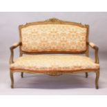 A 19TH CENTURY FRENCH SETTEE, with carved and gilded frame, upholstered with a needlework fabric, on