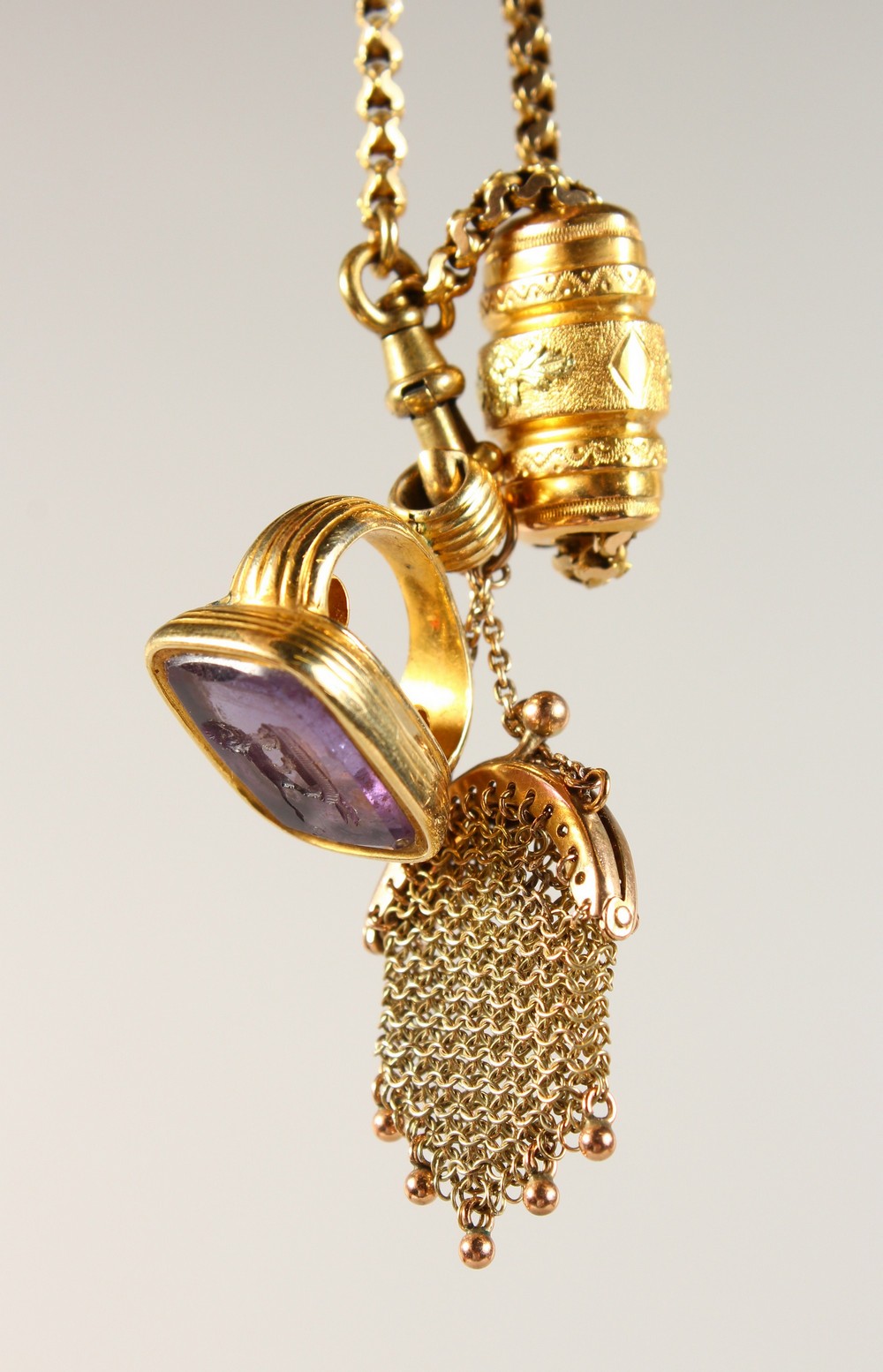 A GOLD FOB SEAL, miniature purse and chain.
