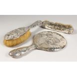 A HAND MIRROR, repousse with angels head, Birmingham 1903, and two brushes (3).