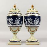 A PAIR OF BLUE AND WHITE PATE-SUR-PATE VASES AND COVERS. 13ins high.