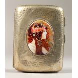 A VICTORIAN HAMMERED SILVER CIGARETTE CASE, Chester 1896, inset with an oval of a Deco girl.