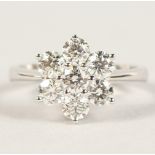 A GOOD 18CT WHITE GOLD DAISY STYLE DIAMOND RING of 1.3cts.