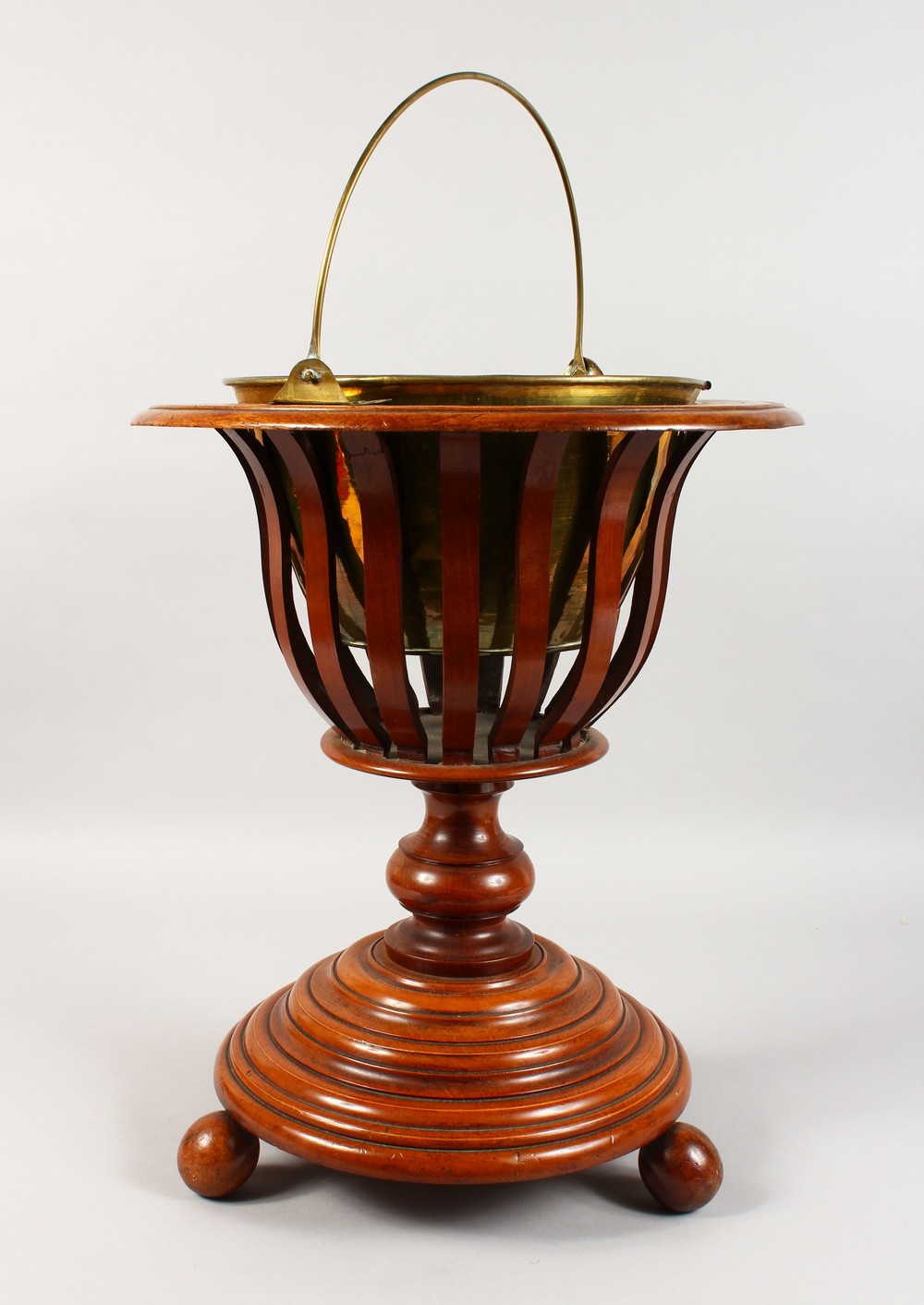 A GOOD DUTCH TWO-COLOUR WOODEN CIRCULAR BUCKET, with brass liner and handle.