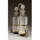 A GOOD SET OF THREE PLAIN AND HOBNAIL CUT DECANTERS AND STOPPERS, in a plated frame with claw