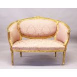 A 19TH CENTURY FRENCH GILT FRAMED CANAPE, with pink ground classical fabric, on turned, fluted