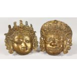 TWO RELIEF MOULD INDIAN BRASS MASKS. 9ins wide.