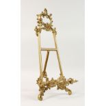 A FRENCH BRASS PICTURE EASEL, with acanthus scroll decoration. 21ins high.