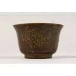 A SMALL CHINESE BRONZE CIRCULAR CUP. 2ins diameter.