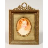 PORTRAIT HEAD AND SHOULDERS OF A YOUNG CHILD in a gilt frame. Oval. 2ins x 1.5ins.