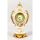 A SMALL FRENCH PORCELAIN CLOCK, painted with flowers and figures, with gilt mounts. 11.5ins high.