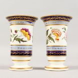 A GOOD PAIR OF VASES, painted with a continuous design of flowers. 3.5ins high.