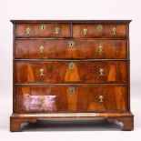 A GOOD 18TH CENTURY WALNUT CHEST OF DRAWERS, with quarter veneered top, two short and three