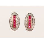 A PAIR OF 9CT GOLD, RUBY AND DIAMOND CALIBRE CUT DECO STYLE EARRINGS.