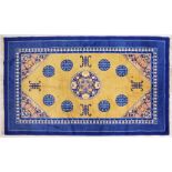 A CHINESE CARPET, with blue border and eight blue medallions. 8ft 2ins x 5ft.
