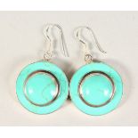 A PAIR OF TURQUOISE AND SILVER EARRINGS.