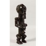 A SMALL FANG TRIBE SEATED FIGURE of a bearded man. 10.5ins high.
