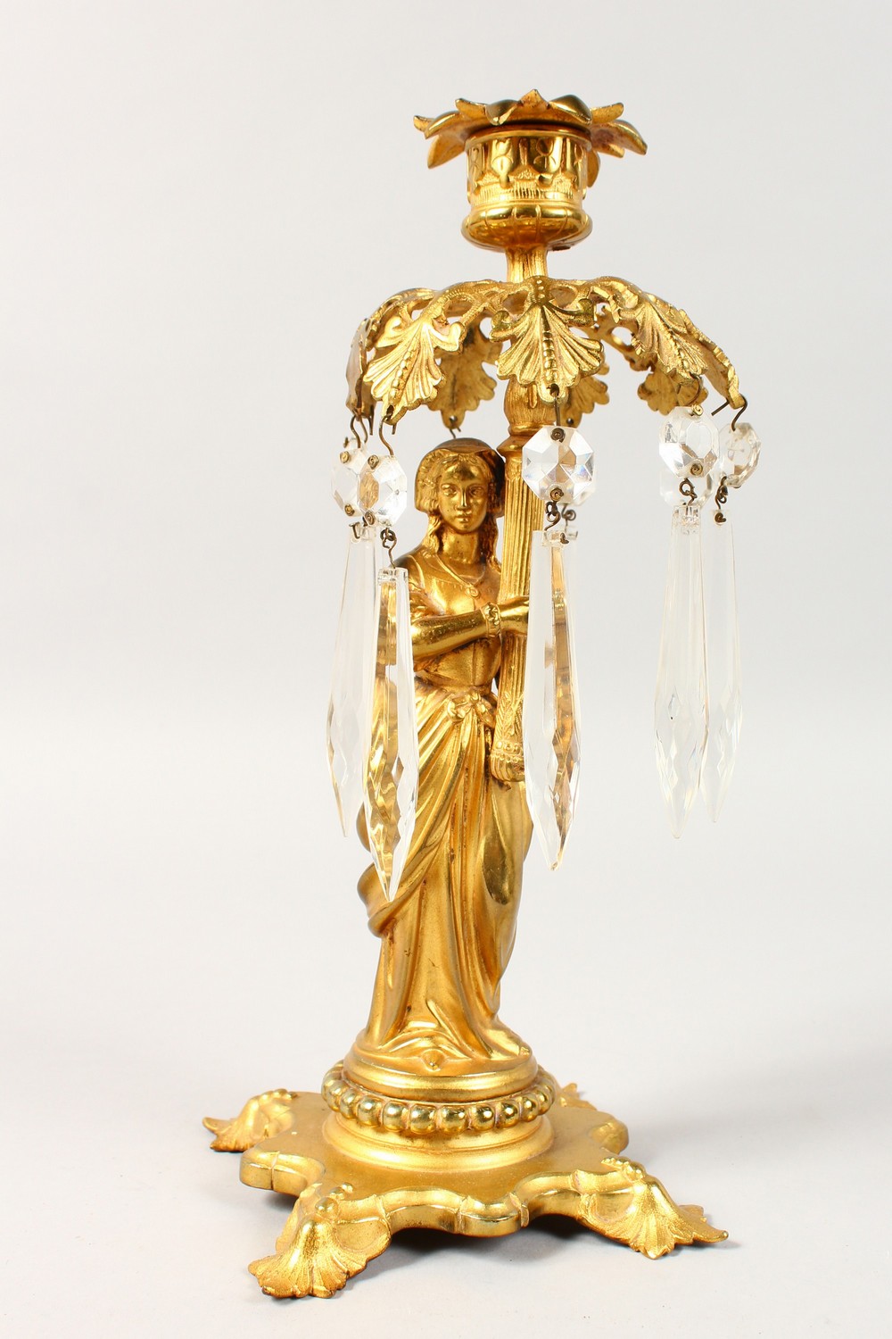 A 19TH CENTURY FRENCH SINGLE LIGHT CANDLESTICK, formed as a classical lady holding a light with