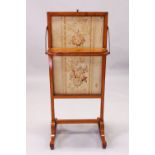 A 19TH CENTURY SATINWOOD FIRE SCREEN, with rising needlework panel, small shelf, on curving