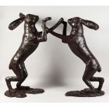 A GOOD LARGE PAIR OF BRONZE BOXING HARES. 30ins high.