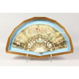 A GOOD 18TH CENTURY FRENCH FAN, in a glazed gilt frame, painted with a classical scene with