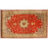 A GOOD PERSIAN CARPET, with central motif, garlands and flowers, within a deep border. 9ft x 6ft.