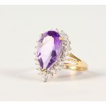 A 9CT GOLD, PEAR SHAPE AMETHYST AND DIAMOND RING.