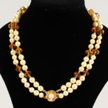 A DOUBLE ROW OF FRESHWATER PEARL NECKLACE, with citrine spacers and gold clasp.