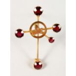 A GOLD AND GARNET SET CROSS BROOCH.