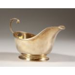 A SAUCEBOAT, with scroll handle and pedestal base. Birmingham 1934. Maker: S. & C. Ltd. 5.5ins