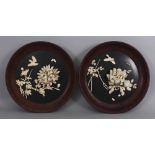A PAIR OF JAPANESE MEIJI PERIOD IVORY ONLAID LACQUERED WOOD CIRCULAR HANGING PANELS, each