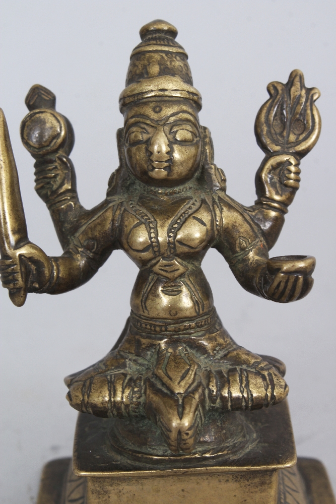 A Brass Figure of Durga, Western Deccan, India, circa 18th century, seated on a raised plinth, the - Image 5 of 6