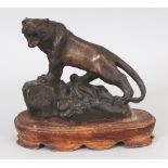 A JAPANESE MEIJI PERIOD BRONZE MODEL OF A TIGER, mounted on a fixed wood stand, the tiger standing