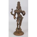 AN INDIAN BRONZE FIGURE OF A FEMALE MULTI-ARMED DEITY, standing on a circular lotus plinth, 12.1in