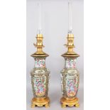 A LARGE PAIR OF 19TH CENTURY CHINESE CANTON PORCELAIN VASES, mounted as oil lamps with gilt metal