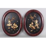 A PAIR OF JAPANESE MEIJI PERIOD MOTHER-OF-PEARL & BONE ONLAID LACQUERED WOOD OVAL HANGING PANELS,