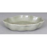 AN UNUSUAL CHINESE CELADON GLAZED PORCELAIN BRUSHWASHER, with a wavy rim, the base unglazed, 5.1in x