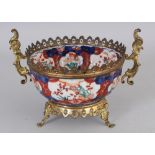 A SIMILARLY MOUNTED GILT BRONZE SMALL JAPANESE IMARI PORCELAIN BOWL, 5.25in diameter at rim & 5in