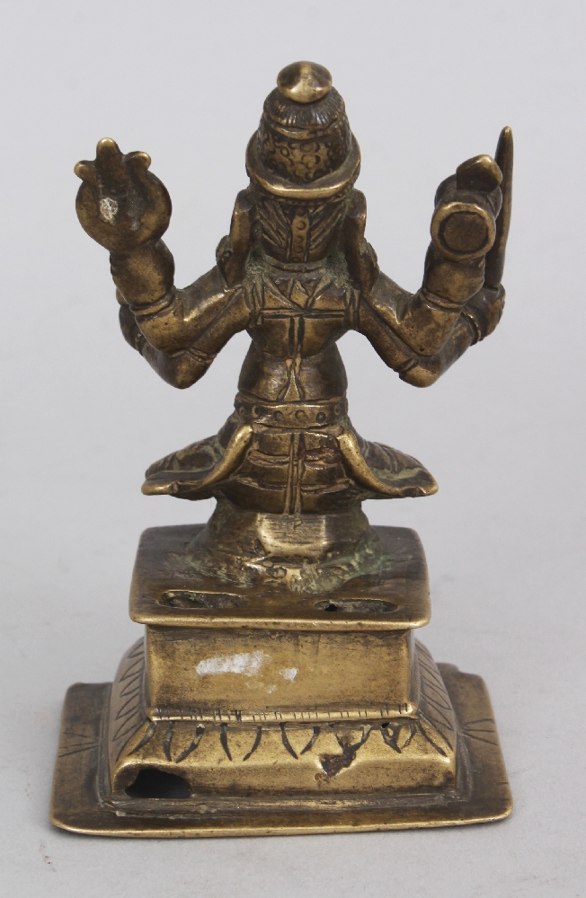 A Brass Figure of Durga, Western Deccan, India, circa 18th century, seated on a raised plinth, the - Image 3 of 6