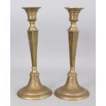 A Pair of Brass Candlesticks, Persia, 20th century, of European form, on splayed foot, with