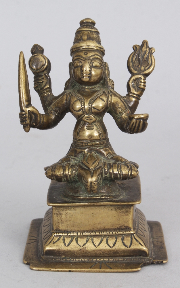 A Brass Figure of Durga, Western Deccan, India, circa 18th century, seated on a raised plinth, the