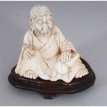 A GOOD QUALITY 19TH CENTURY CHINESE IVORY CARVING OF A SEATED SAGE, together with a fitted wood
