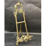 19th Century English School. An Ornately Cast Brass Easel, 21.25" x 9.5", and three companion